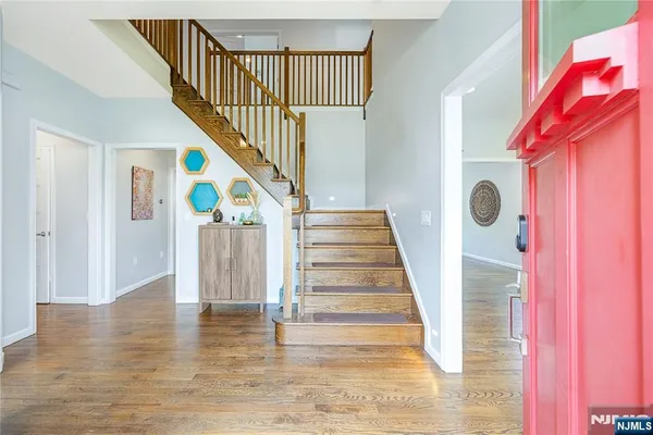 a dining room with wooden floor a glass table and chairs