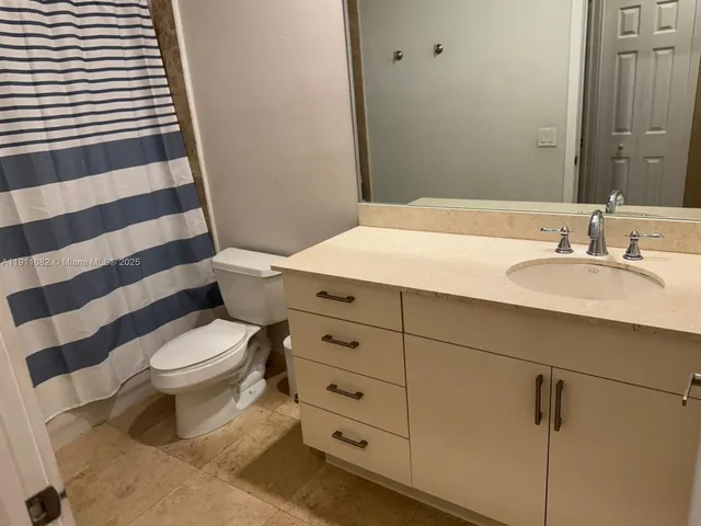 a bathroom with a sink a toilet a shower and a mirror
