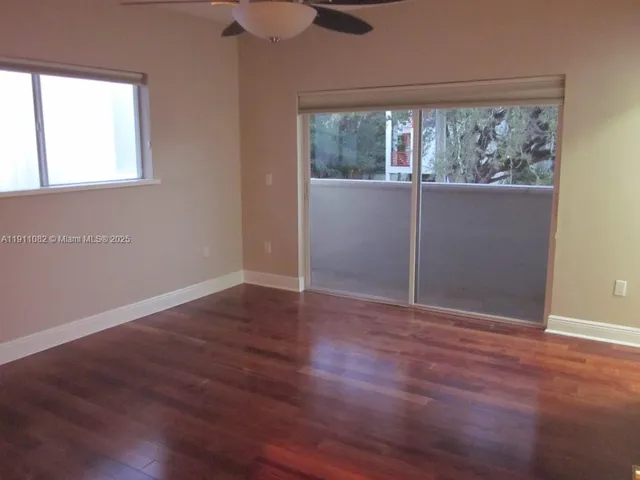 a view of a room with wooden floor and a window
