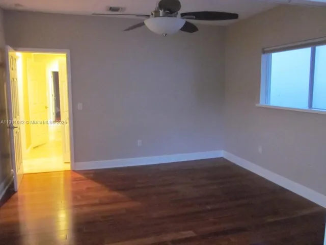 a view of a hallway with wooden shelves