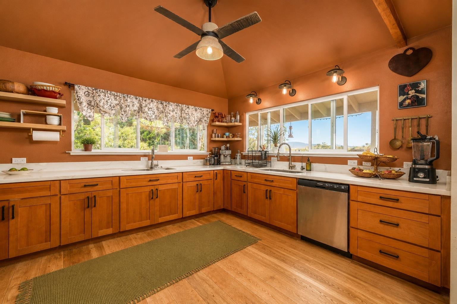 1660 Kokomo Road Haiku, HI 96708 - Photo 11 of 43 a kitchen with stainless steel appliances granite countertop a sink and cabinets with wooden floor