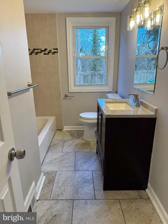 a bathroom with a sink a toilet and a shower