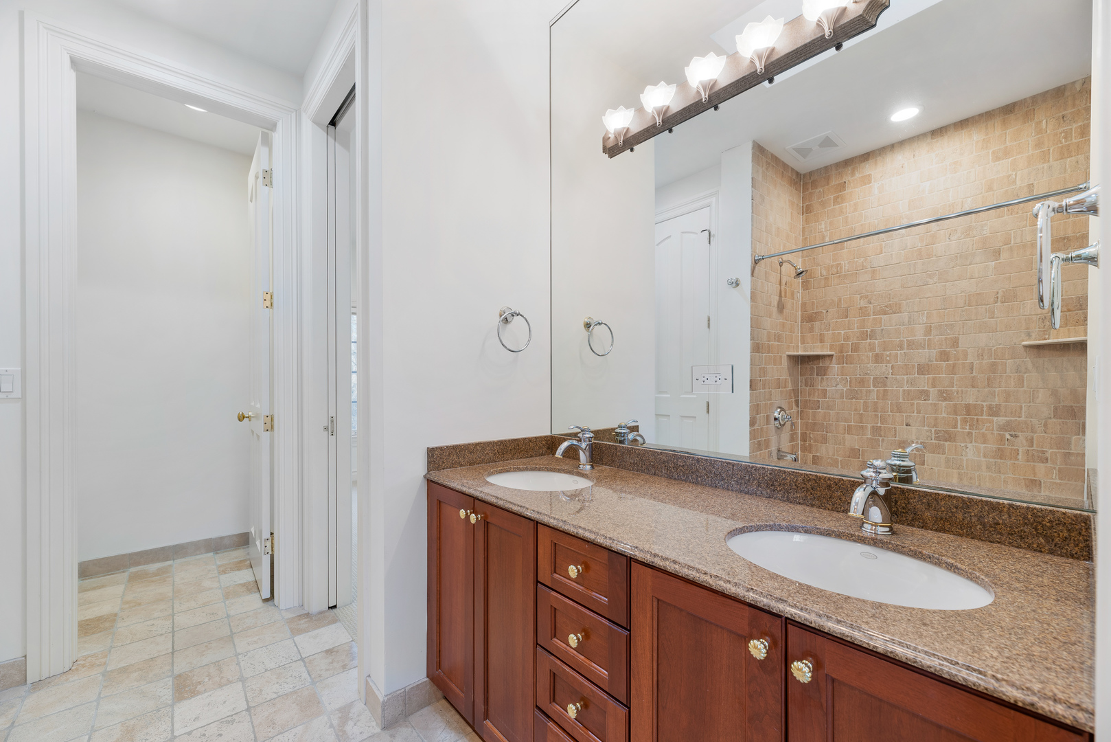 130 Maple Hill Road Glencoe, IL 60022 - Photo 38 of 54 a bathroom with a granite countertop sink a mirror and a shower