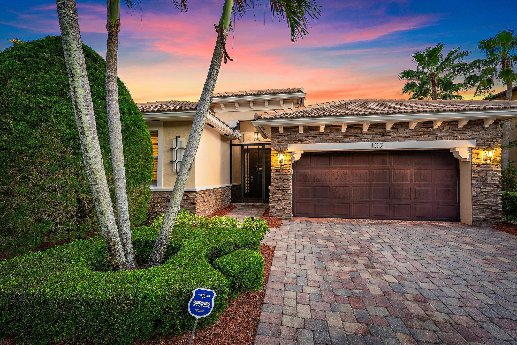 102 Crab Cay Way Jupiter, FL 33458 - Photo 1 of 59 a front view of a house with a garden