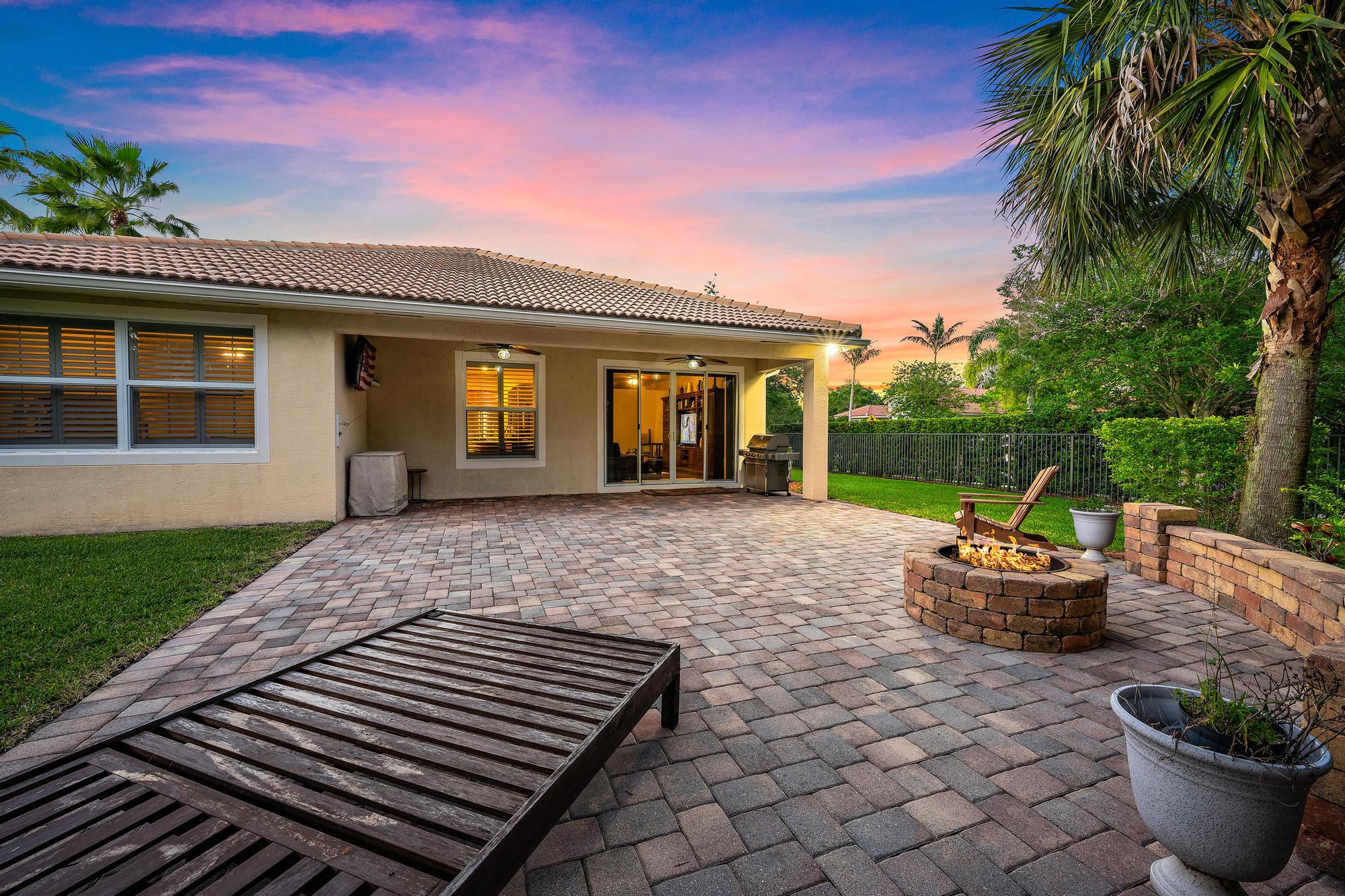 102 Crab Cay Way Jupiter, FL 33458 - Photo 2 of 59 a front view of a house with a garden