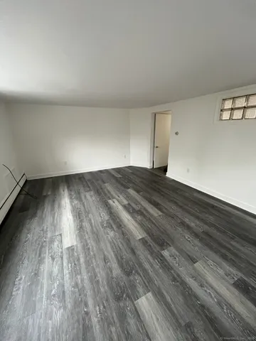 a view of an empty room and wooden floor