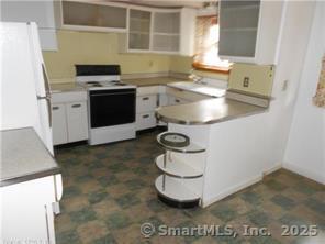8 Burnham Street, Unit 2A Plymouth, CT 06786 - Photo 3 of 13 a kitchen with a sink a stove and cabinets