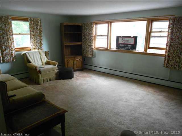 8 Burnham Street, Unit 2A Plymouth, CT 06786 - Photo 4 of 13 a living room with furniture and a flat screen tv