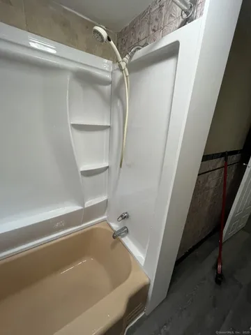 a bathroom with a tub and a shower