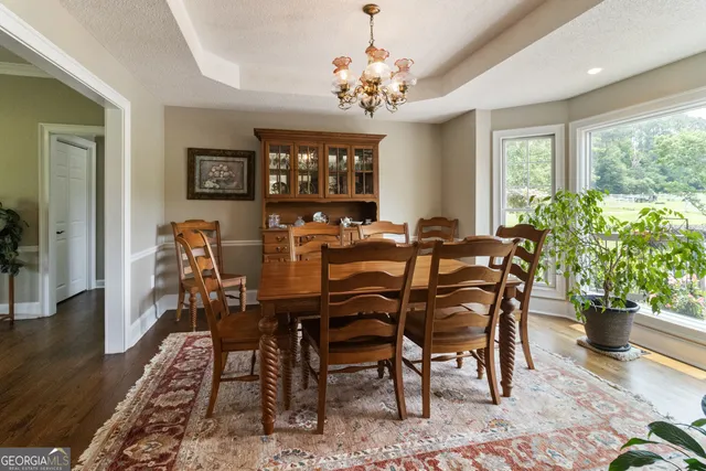 a view of a dining room with furniture window and wooden floor