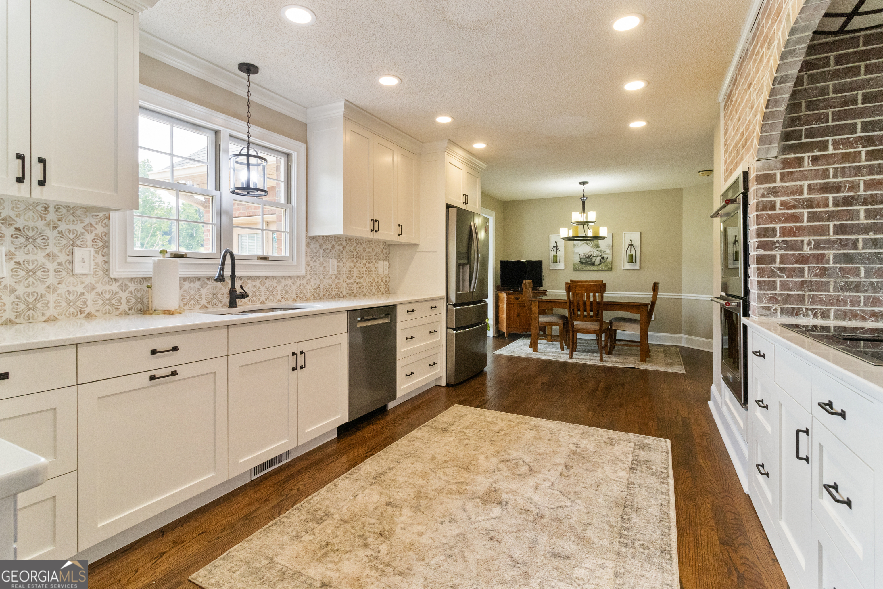 3890 Newnan Road Williamson, GA 30292 - Photo 15 of 57 a large kitchen with stainless steel appliances kitchen island granite countertop a sink and cabinets