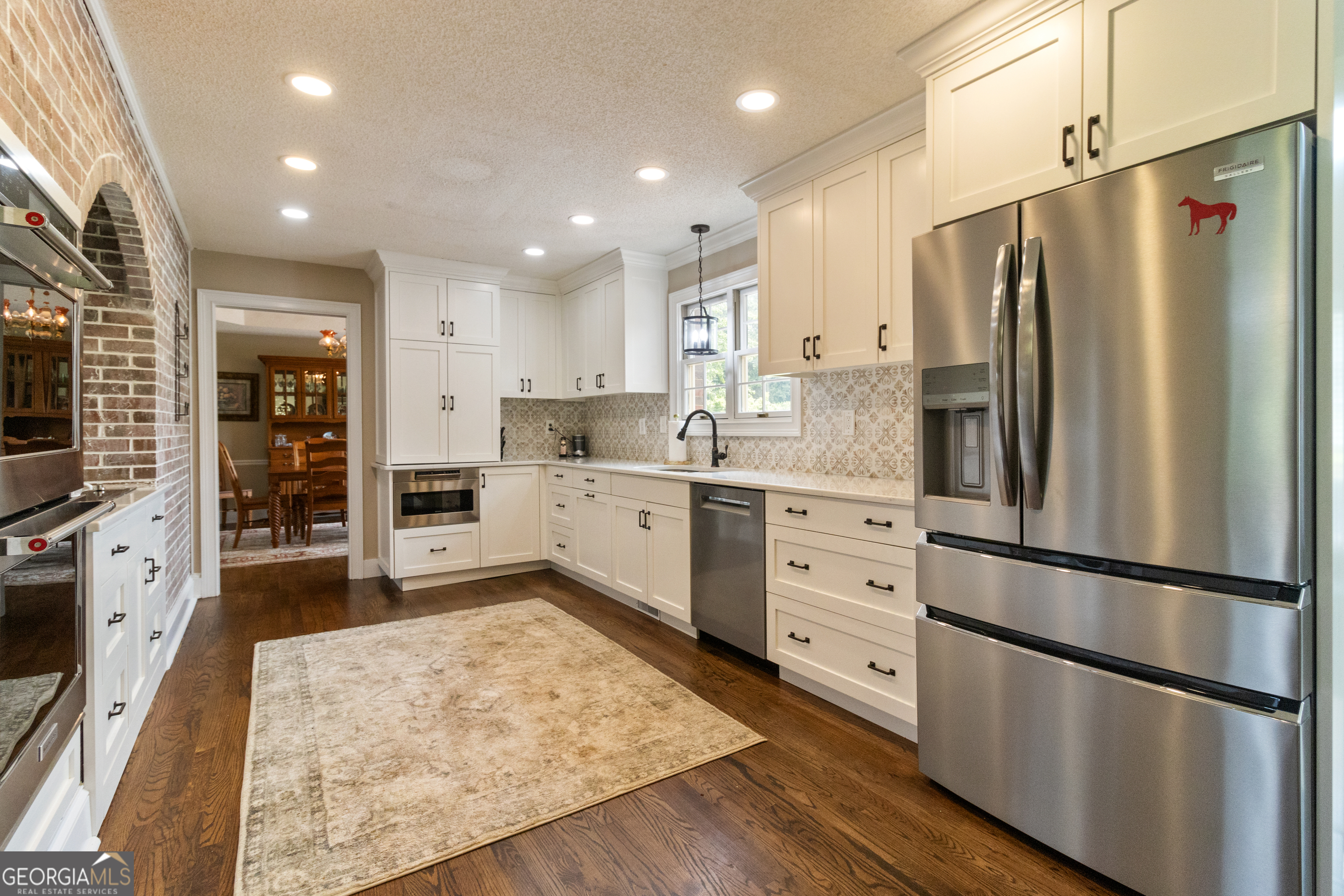 3890 Newnan Road Williamson, GA 30292 - Photo 16 of 57 a kitchen with stainless steel appliances a refrigerator sink and cabinets