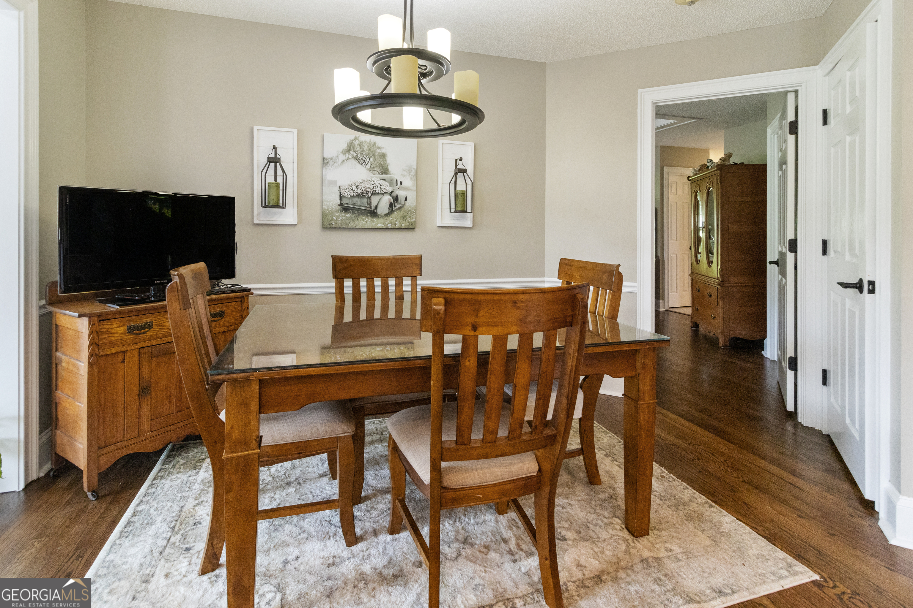 3890 Newnan Road Williamson, GA 30292 - Photo 19 of 57 a dining room with furniture a chandelier and wooden floor