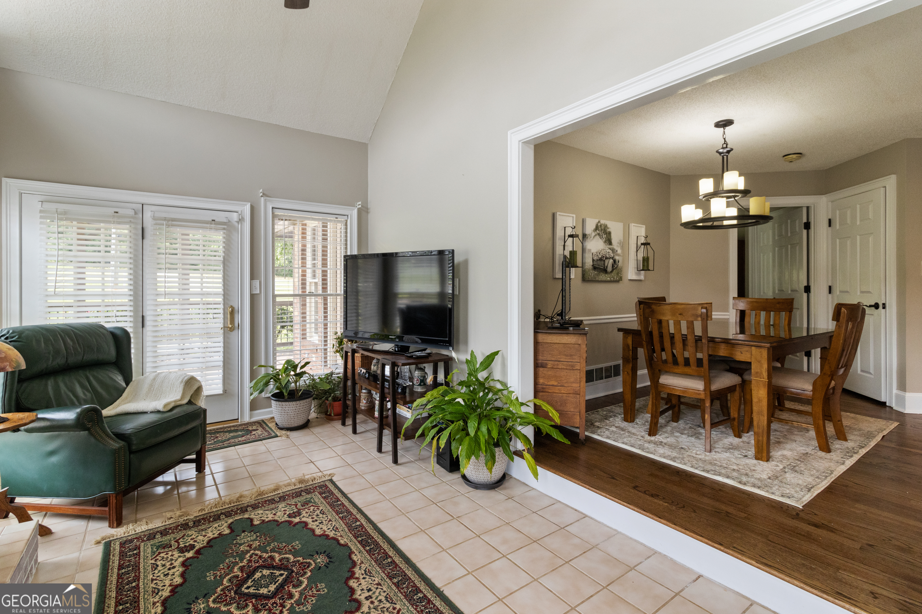 3890 Newnan Road Williamson, GA 30292 - Photo 22 of 57 a living room with furniture a dining table and a flat screen tv