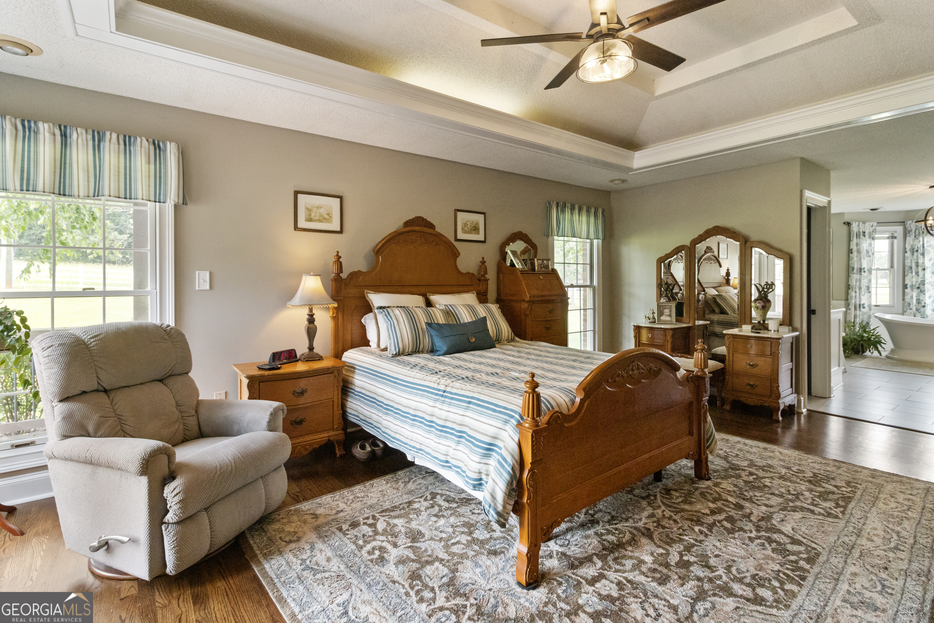 3890 Newnan Road Williamson, GA 30292 - Photo 24 of 57 a bedroom with a bed and wooden floor