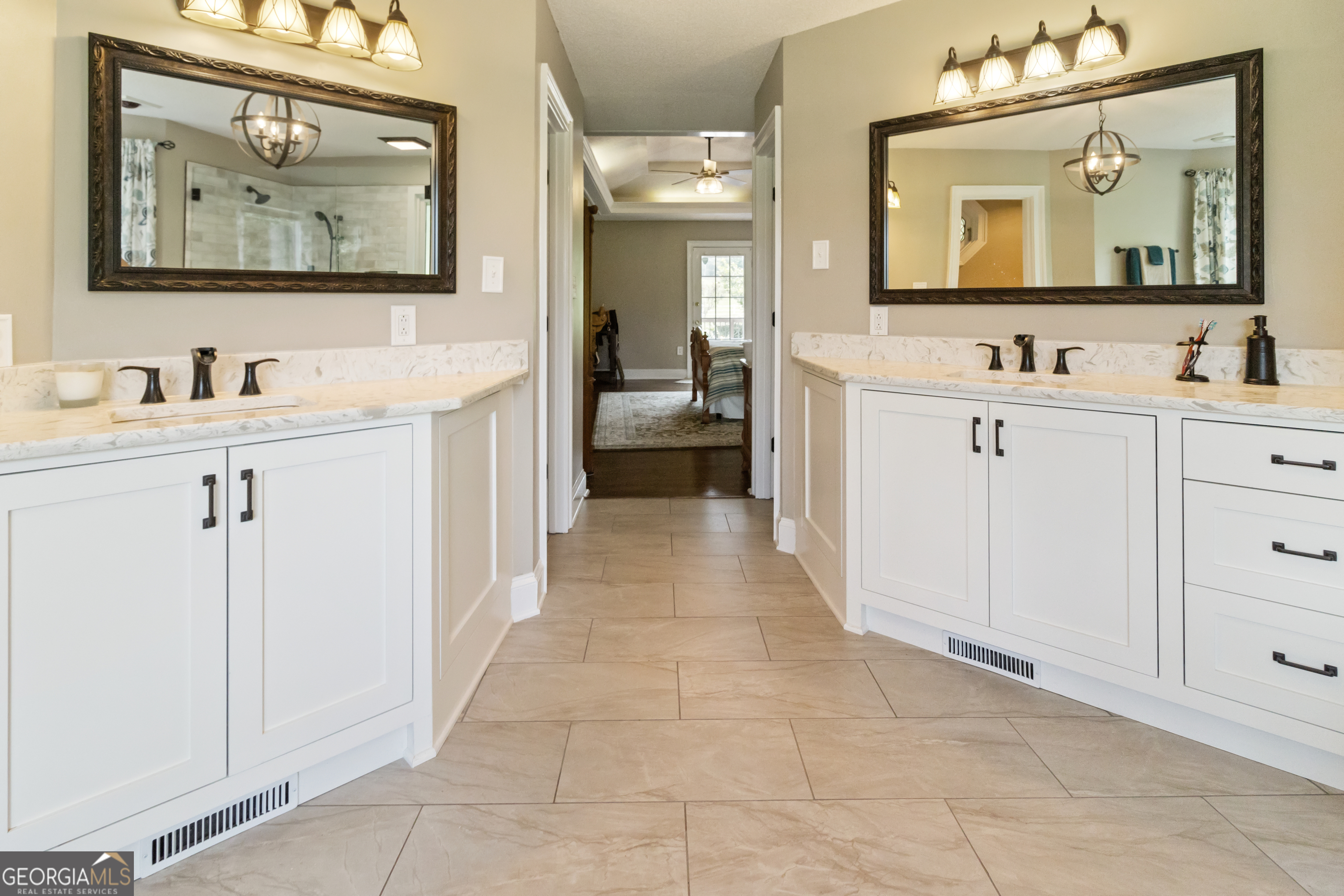 3890 Newnan Road Williamson, GA 30292 - Photo 27 of 57 a bathroom with double vanity sinks a large mirror and a shower
