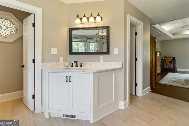 a bathroom with a sink vanity and a mirror