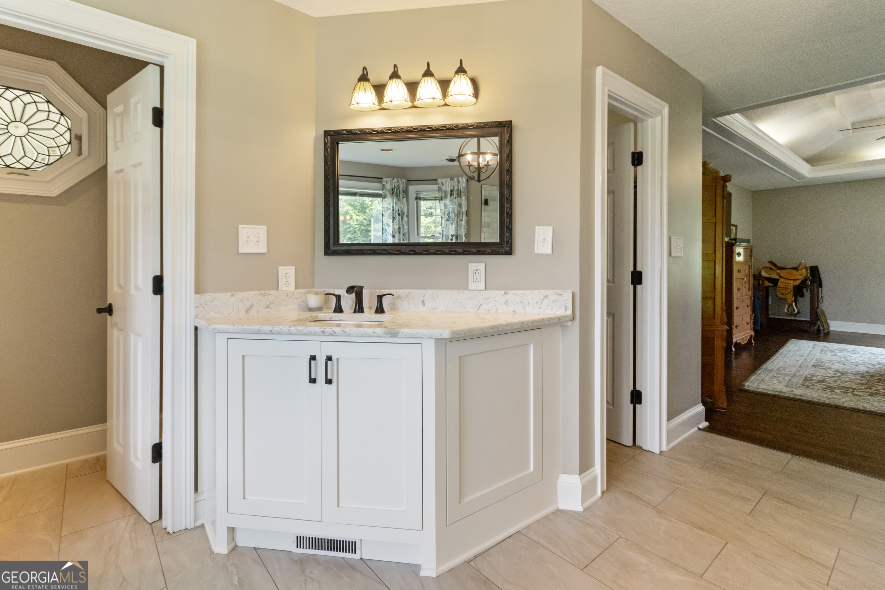3890 Newnan Road Williamson, GA 30292 - Photo 28 of 57 a bathroom with a sink vanity and a mirror