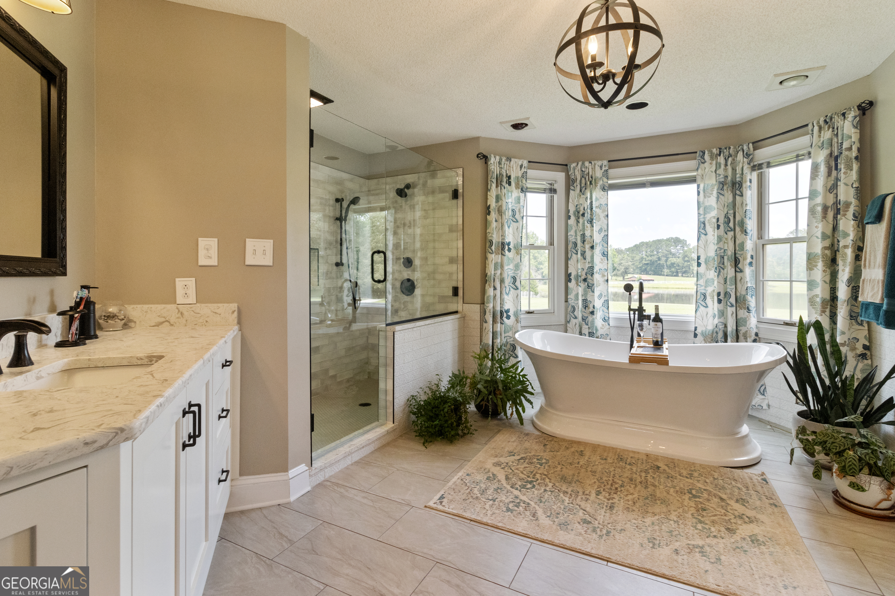 3890 Newnan Road Williamson, GA 30292 - Photo 32 of 57 a spacious bathroom with a tub a sink and glass door