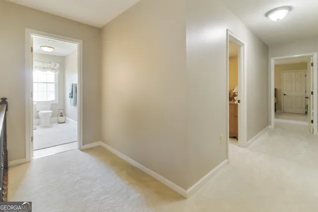 a spacious bedroom with a bed and a chandelier