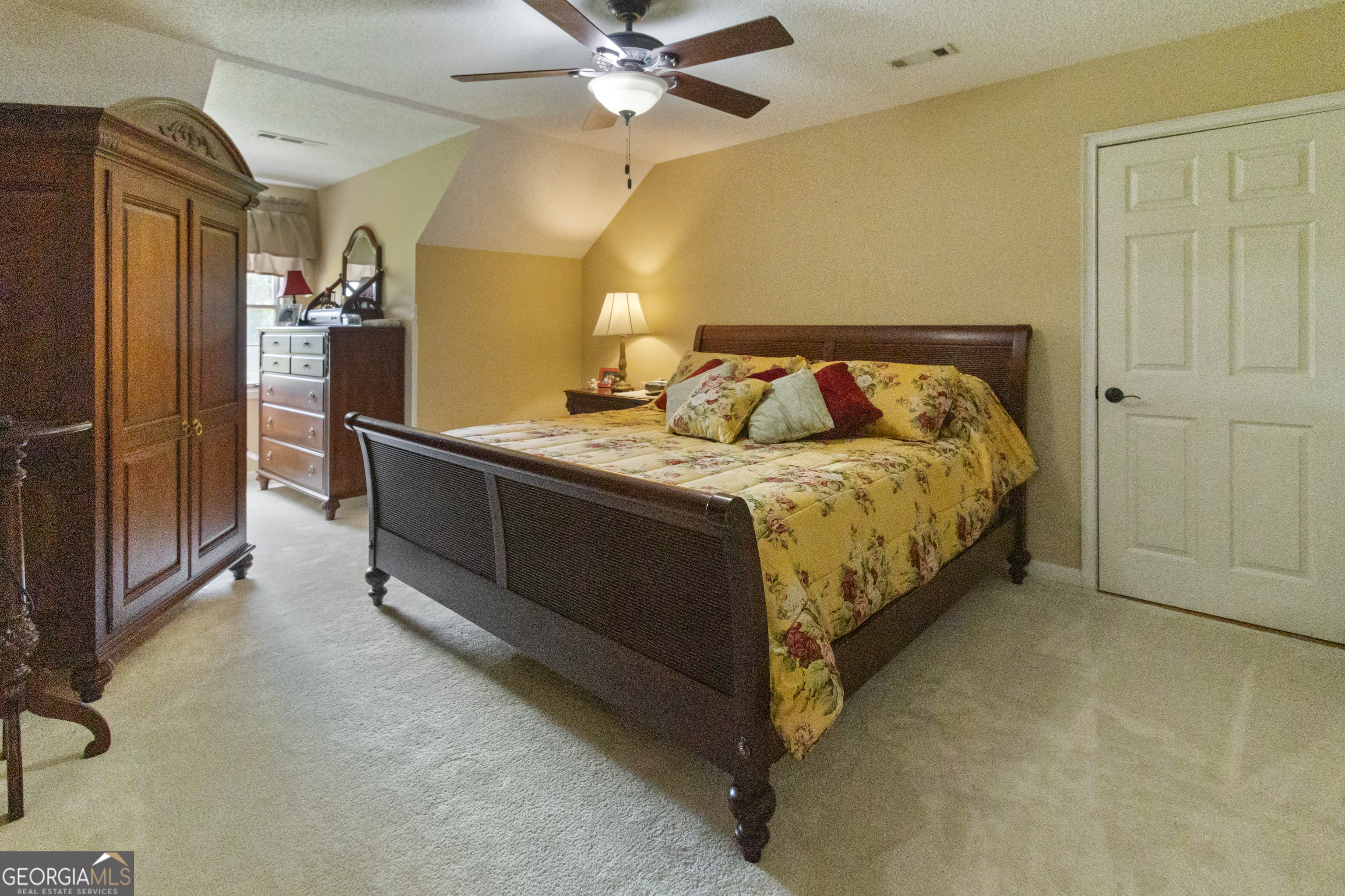 3890 Newnan Road Williamson, GA 30292 - Photo 36 of 57 a bedroom with a bed and a chandelier