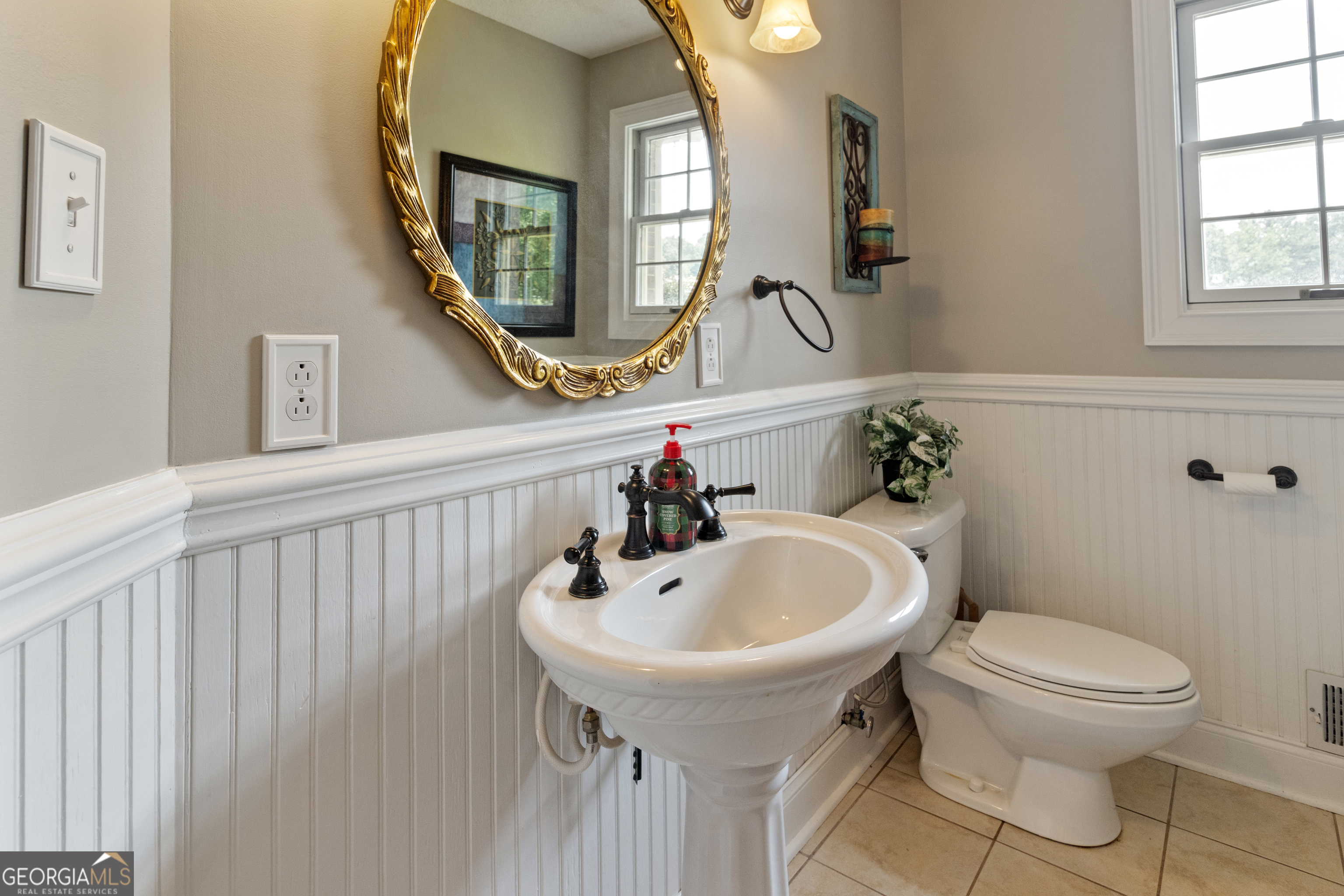3890 Newnan Road Williamson, GA 30292 - Photo 40 of 57 a bathroom with a toilet sink and mirror