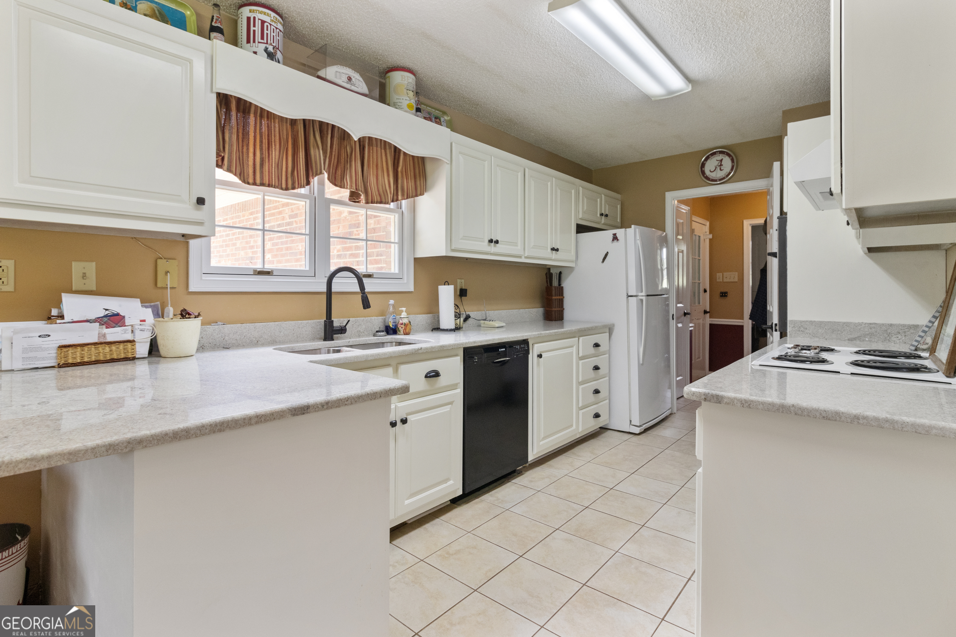3890 Newnan Road Williamson, GA 30292 - Photo 46 of 57 a kitchen with a sink window and cabinets