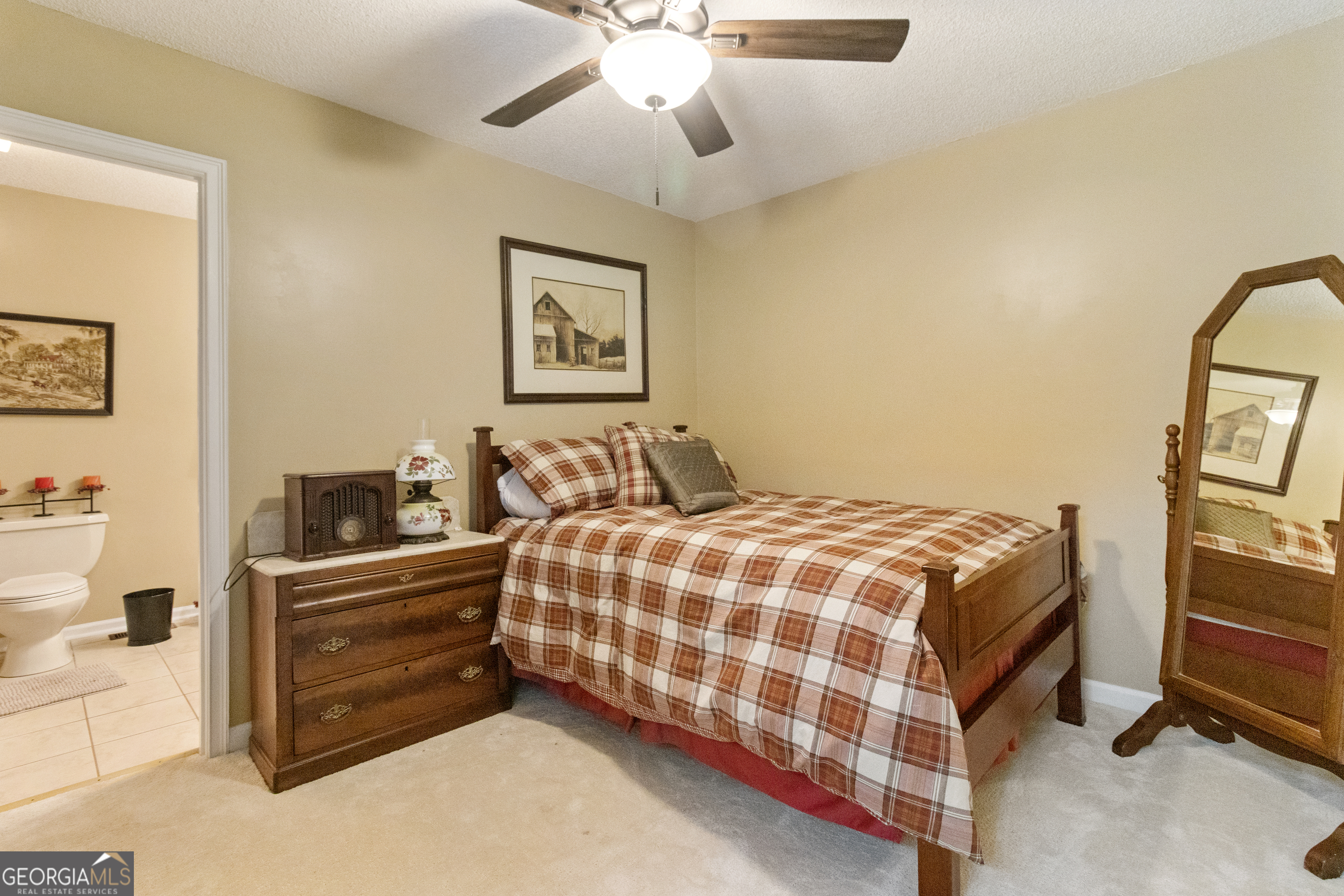 3890 Newnan Road Williamson, GA 30292 - Photo 48 of 57 a bedroom with a bed and a chandelier