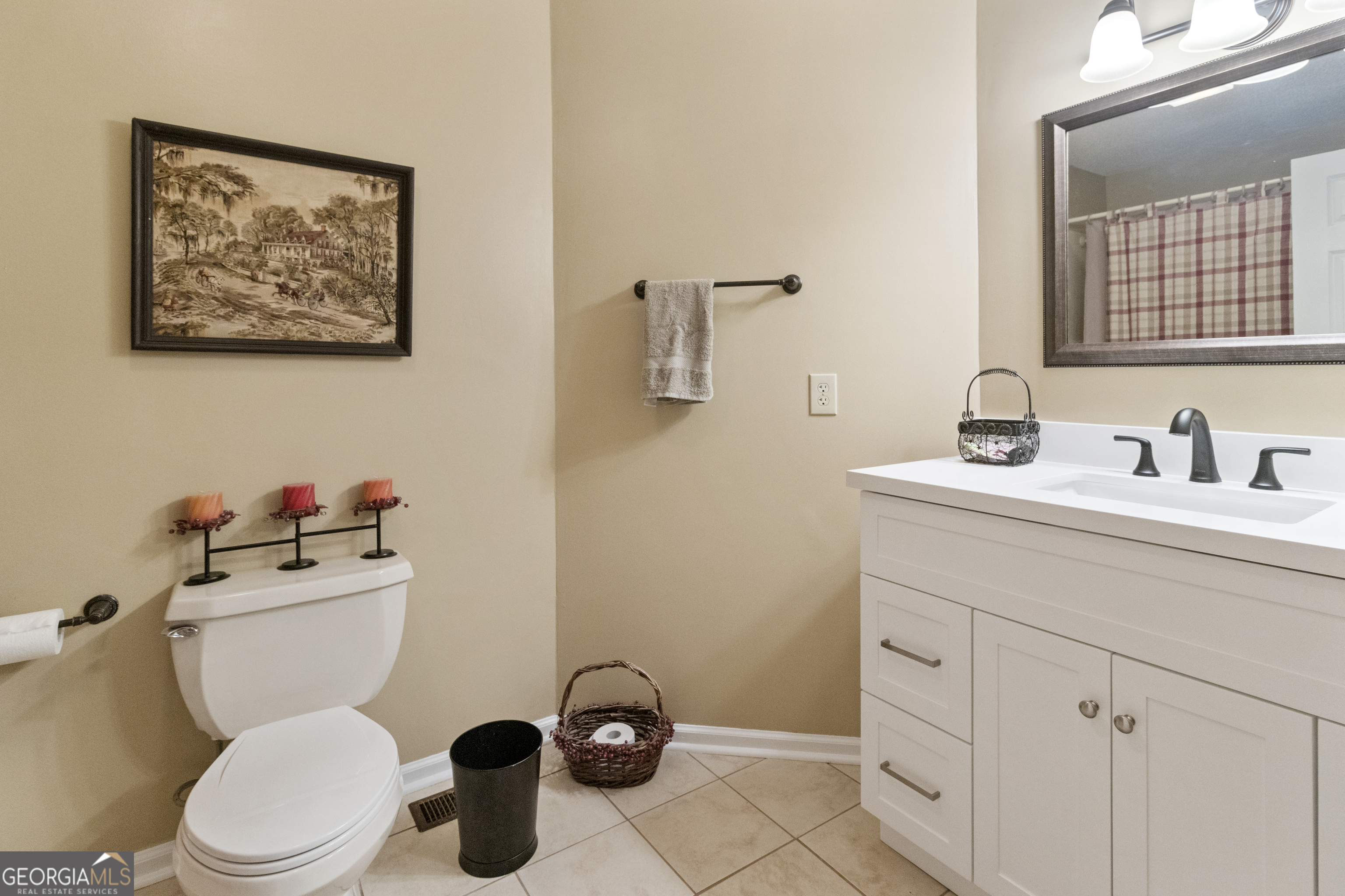 3890 Newnan Road Williamson, GA 30292 - Photo 49 of 57 a bathroom with a toilet sink and mirror