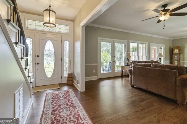 a living room with furniture a fireplace and a chandelier