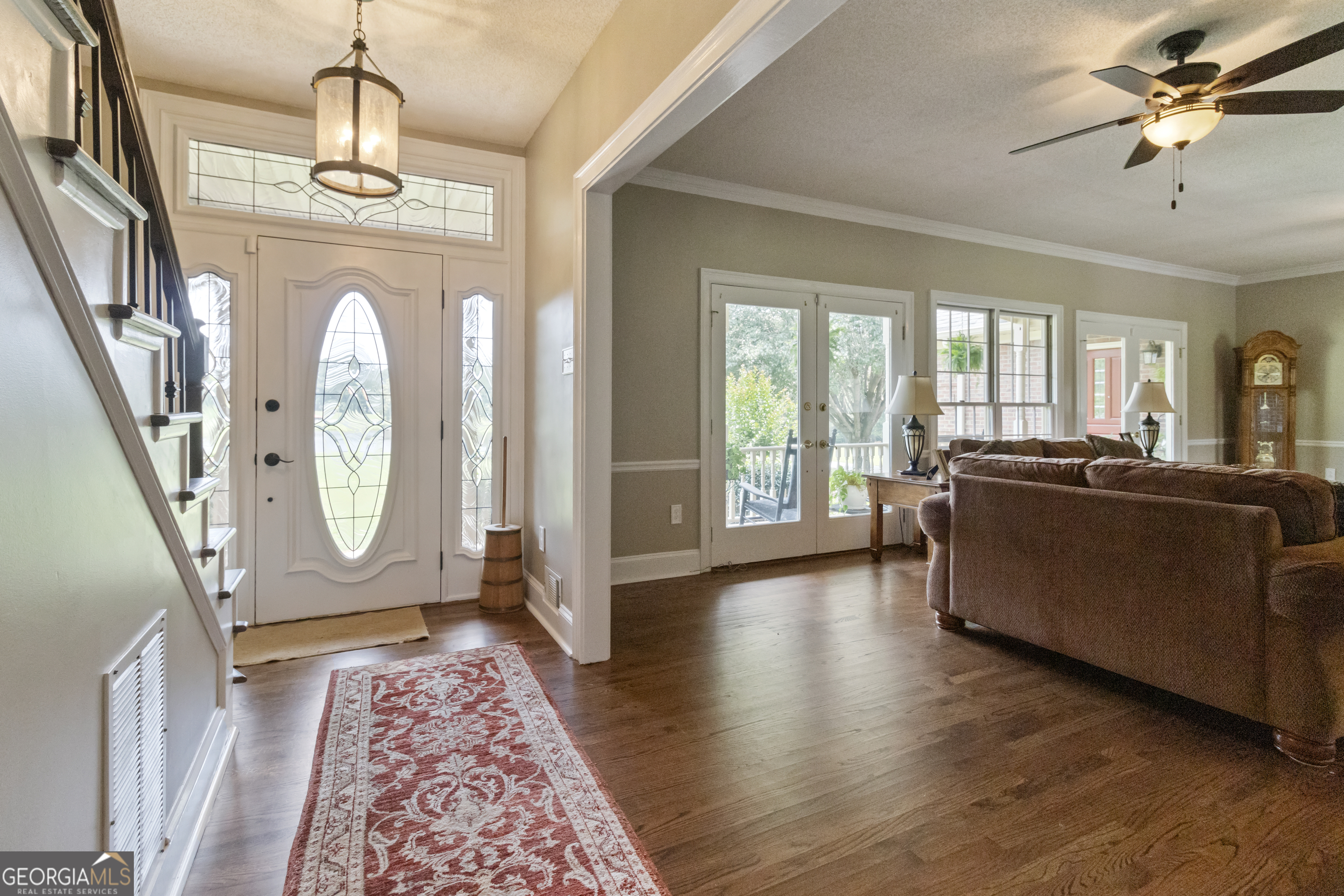 3890 Newnan Road Williamson, GA 30292 - Photo 8 of 57 a living room with furniture a fireplace and a chandelier