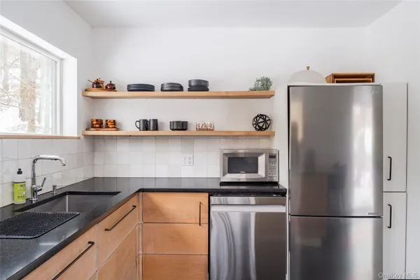a kitchen with refrigerator and cabinets