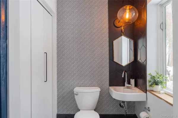 a bathroom with a toilet sink and mirror