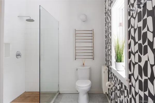a bathroom with a toilet and shower curtain