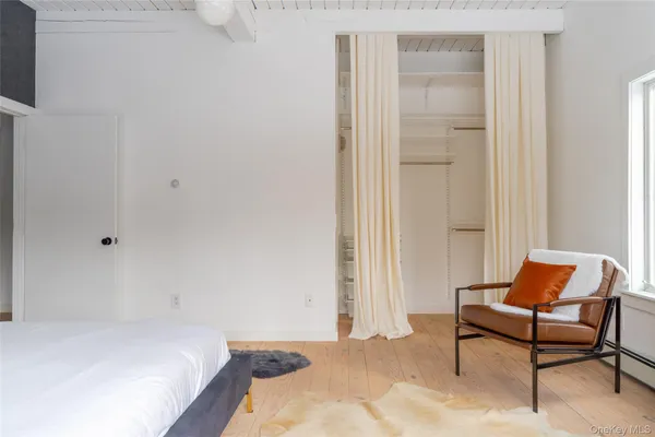 a bedroom with a bed and a chair