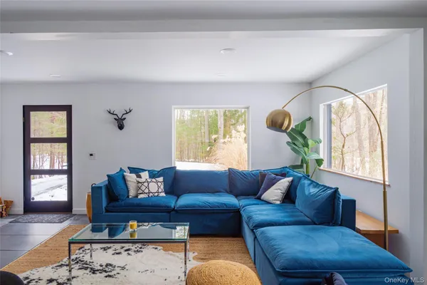 a living room with furniture and a large window