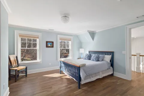 a bedroom with a bed a table and chair