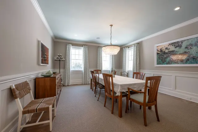 a bedroom with a bed and a flat tv screen on dresser