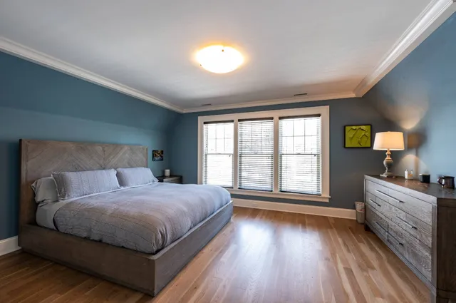 a spacious bathroom with a granite countertop sink a mirror and a bathtub