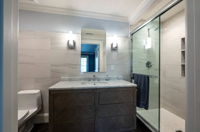 a bedroom with a bed lamp closet and large window