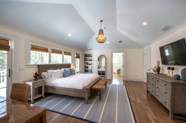 a bedroom with a bed and a chandelier