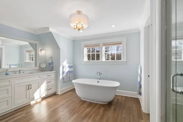 a bathroom with a double vanity sink toilet and shower