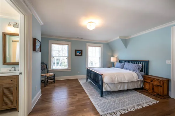 a bedroom with a bed and a refrigerator
