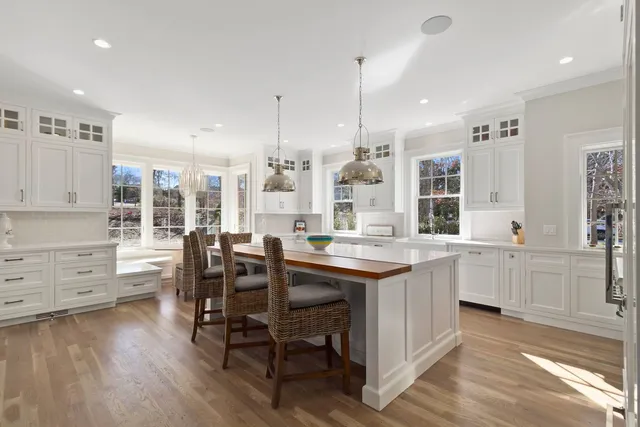 a kitchen with center island appliances and wooden floor