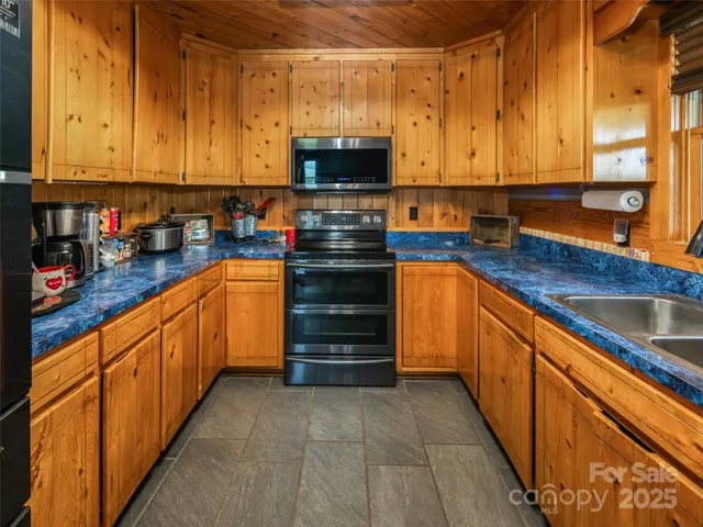 a bedroom with bed and a chandelier