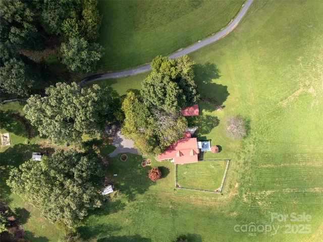 a view of a big yard with table and chairs