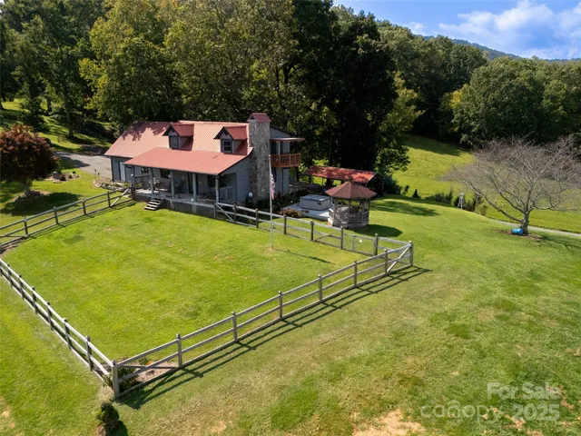 a view of a lush green hillside and a houses