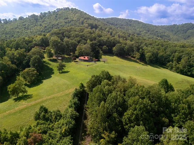 an aerial view of a house with a garden and swimming pool