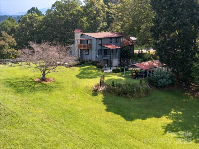 a view of a swimming pool with a table and chairs under an umbrella
