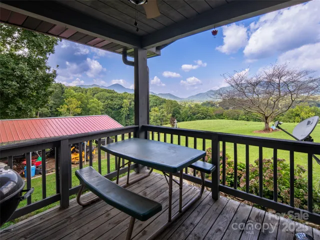 a view of a balcony with furniture and wooden floor